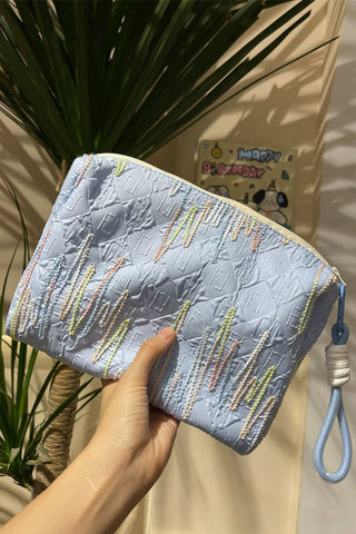 Embellished Textured Tassel Cosmetic Bag