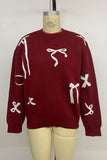 Festive Bow-Patterned Sweater