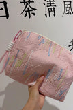 Embellished Textured Tassel Cosmetic Bag